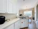 Contemporary kitchen featuring a stainless steel sink, dishwasher, and sleek white cabinetry at 802 Brunello Dr, Davenport, FL 33897