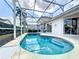 Sparkling screened-in pool featuring a serene retreat with clear blue water for relaxation and enjoyment at 802 Brunello Dr, Davenport, FL 33897