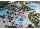 Aerial view of community pools with resort-style amenities including splash pad, pools, and cabanas at 8885 Cabot Cliffs Dr # 103, Davenport, FL 33896