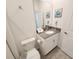 This functional bathroom includes a vanity with a solid surface countertop, toilet, and neutral wall decor at 8885 Cabot Cliffs Dr # 103, Davenport, FL 33896