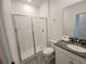 Modern bathroom featuring a glass-enclosed shower, gray vanity, and neutral finishes for a clean, contemporary look at 8885 Cabot Cliffs Dr # 103, Davenport, FL 33896