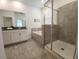 Bathroom featuring tile floors, white cabinets, soaking tub, and walk-in shower with glass doors at 8885 Cabot Cliffs Dr # 103, Davenport, FL 33896