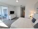 Comfortable bedroom with a view of the balcony, soft carpeting, and ample closet space at 8885 Cabot Cliffs Dr # 103, Davenport, FL 33896