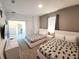 This bedroom has two beds, neutral decor and access to a laundry room and creates a welcoming atmosphere at 8885 Cabot Cliffs Dr # 103, Davenport, FL 33896