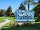Oasis Clubhouse at ChampionsGate sign surrounded by lush greenery, providing a welcoming entrance to the community's amenities at 8885 Cabot Cliffs Dr # 103, Davenport, FL 33896