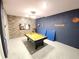 Spacious game room with a pool table, TV, and basketball decor for entertainment and leisure activities at 8885 Cabot Cliffs Dr # 103, Davenport, FL 33896