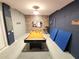 Fun game room with a full-size pool table, exposed brick, and a painted cinder block wall at 8885 Cabot Cliffs Dr # 103, Davenport, FL 33896