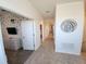Hallway connecting rooms featuring tile floors, white walls, and a decorative wall art at 8885 Cabot Cliffs Dr # 103, Davenport, FL 33896