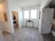 Hallway with a view into the laundry room and adjacent bedroom, complemented by contemporary decor and neutral tones at 8885 Cabot Cliffs Dr # 103, Davenport, FL 33896