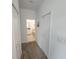 Hallway with carpet floors, white walls, and a bathroom view for added convenience at 8885 Cabot Cliffs Dr # 103, Davenport, FL 33896