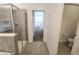 Hallway connecting the bathroom and bedroom; shower with glass doors at 8885 Cabot Cliffs Dr # 103, Davenport, FL 33896
