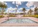Community hot tub with a lift for handicap accessibility and a view of the resort-style pool area at 8885 Cabot Cliffs Dr # 103, Davenport, FL 33896