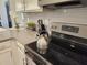 Close-up of the kitchen's range, showcasing modern appliances and sleek countertops at 8885 Cabot Cliffs Dr # 103, Davenport, FL 33896