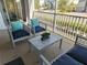 Screened in patio with outdoor seating arrangement, cushions and coffee table at 8885 Cabot Cliffs Dr # 103, Davenport, FL 33896