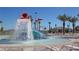 Community splash pad featuring a large bucket that pours water onto a slide in a circular wading pool at 8885 Cabot Cliffs Dr # 103, Davenport, FL 33896