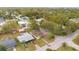 Aerial view of the property and neighborhood with mature trees and well-kept lawns at 900 Delaware Ave, St Cloud, FL 34769