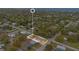 Aerial view of a property with a neighborhood and waterway in the background at 900 Delaware Ave, St Cloud, FL 34769