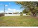Expansive backyard with mature trees, offering ample space and privacy at 900 Delaware Ave, St Cloud, FL 34769