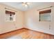 Bedroom with wooden floors and two windows with wooden blinds at 900 Delaware Ave, St Cloud, FL 34769
