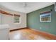 Bedroom featuring hardwood floors and multiple windows for great natural light at 900 Delaware Ave, St Cloud, FL 34769