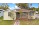 Charming single-story home with a cozy front porch and well-maintained lawn at 900 Delaware Ave, St Cloud, FL 34769