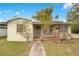 Charming single-story home featuring a brick walkway and cozy front porch at 900 Delaware Ave, St Cloud, FL 34769