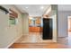 A well lit kitchen with tile floor and wooden cabinets, black appliances at 900 Delaware Ave, St Cloud, FL 34769