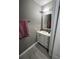 Cozy bathroom featuring vanity with a sink and storage cabinet, complemented by neutral walls at 920 Gillingham Ct, Kissimmee, FL 34758