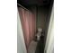 Bathroom with a toilet, shower with pink shower curtain, and a striped rug at 920 Gillingham Ct, Kissimmee, FL 34758