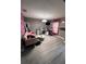 Bedroom with a pink sofa, vanity, mirror, and television at 920 Gillingham Ct, Kissimmee, FL 34758