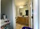 Well-lit bathroom featuring a dual sink vanity and tile floors at 11446 Jasper Kay Ter # 106, Windermere, FL 34786