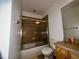 Bathroom featuring wood vanity, matching tile floors, and shower-tub combo at 11446 Jasper Kay Ter # 106, Windermere, FL 34786