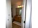 Bathroom featuring wood vanity, matching tile floors, shower-tub combo and linen closet at 11446 Jasper Kay Ter # 106, Windermere, FL 34786