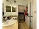 Bathroom with a dual sink vanity that leads to a walk-in closet at 11446 Jasper Kay Ter # 106, Windermere, FL 34786