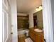 Bathroom features a wood vanity, matching tile floors, and shower-tub combo at 11446 Jasper Kay Ter # 106, Windermere, FL 34786