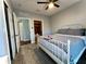 Bedroom featuring wood-look tile floors, ceiling fan, and ensuite bathroom at 11446 Jasper Kay Ter # 106, Windermere, FL 34786
