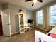 Well-lit bedroom features two windows, closet, wood-look tile floors and white furnishings at 11446 Jasper Kay Ter # 106, Windermere, FL 34786