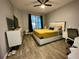 Comfortable bedroom featuring a stylish bed, dark curtains, and wood floors at 11446 Jasper Kay Ter # 106, Windermere, FL 34786