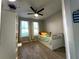 Cozy bedroom featuring a ceiling fan, two windows, and a trundle bed with tile floors at 11446 Jasper Kay Ter # 106, Windermere, FL 34786