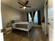 This is a primary bedroom with wood-look tile floors and a ceiling fan at 11446 Jasper Kay Ter # 106, Windermere, FL 34786