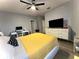 Well-lit bedroom featuring a large TV and a modern ceiling fan at 11446 Jasper Kay Ter # 106, Windermere, FL 34786
