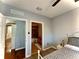 Bedroom featuring wood-look tile, ensuite bathroom, and access to the hallway at 11446 Jasper Kay Ter # 106, Windermere, FL 34786