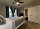 This bedroom features wood-look tile floors, a ceiling fan, and sliding closet doors at 11446 Jasper Kay Ter # 106, Windermere, FL 34786