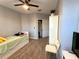 Bright bedroom features closet and wardrobe, ceiling fan, and wood-look tile floors at 11446 Jasper Kay Ter # 106, Windermere, FL 34786