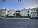 Attractive exterior view of a multi-story condo complex with beautiful landscaping and parking at 11446 Jasper Kay Ter # 106, Windermere, FL 34786