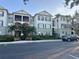 Exterior view of a condo building featuring manicured landscaping, benches, and reserved parking at 11446 Jasper Kay Ter # 106, Windermere, FL 34786