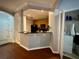 Functional kitchen with a peninsula counter overlooking laundry room, and living area at 11446 Jasper Kay Ter # 106, Windermere, FL 34786