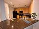 Practical kitchen with efficient design, dark countertops and cabinetry at 11446 Jasper Kay Ter # 106, Windermere, FL 34786
