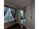 Inviting living room has sheer curtains, a large window and sliding door to the screened porch at 11446 Jasper Kay Ter # 106, Windermere, FL 34786