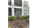 Ground level patio with screen enclosure and green shrubs at 11446 Jasper Kay Ter # 106, Windermere, FL 34786